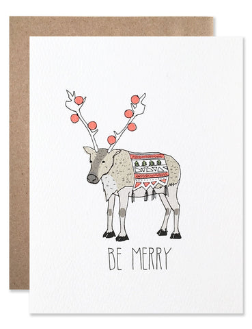 Be Merry reindeer with neon ornaments hanging from the antlers and a festive blanket. Illustration by Hartland Brooklyn