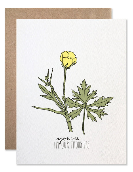 Single yellow buttercup bud with 'you're in our thoughts' written below. Illustration by Hartland Brooklyn.