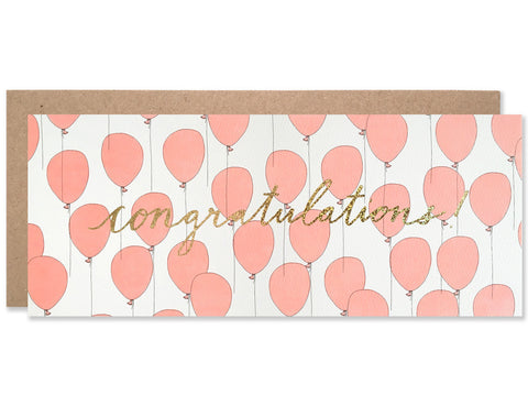 Congratulations script centered and written in gold glitter foil with a neon red balloon pattern behind it. Illustration and handwriting by Hartland Brooklyn.