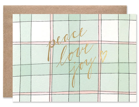 Peace Love Joy gold foil handwriting on a green and red plaid background. Illustrated by Hartland Brooklyn